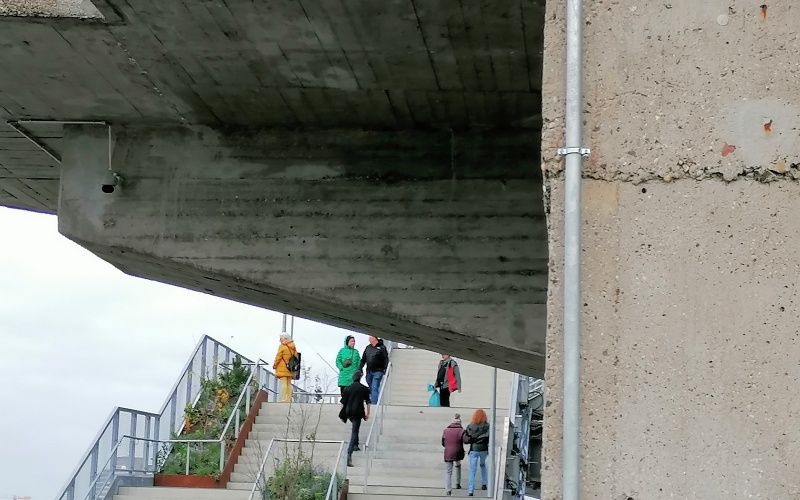 Gebäudeansicht mit Betonfassade, an der eine Kamera montiert ist